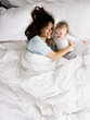 mother and baby in bed