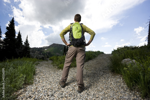 Photo: hiker choosing which path to take hiker choosing which path to take