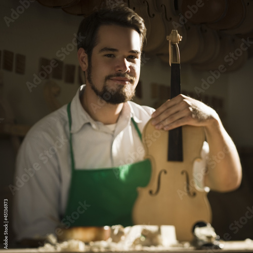 Photo: violin maker in the workshop violin maker in the workshop