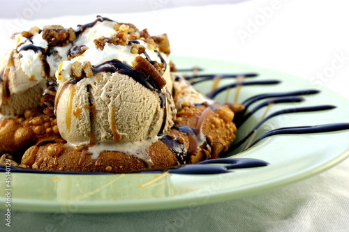 Photo: Warm pretzel topped with ice cream and nuts. Warm pretzel topped with ice cream and nuts.