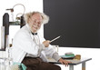 Smiling eccentric  scientist points to blackboard