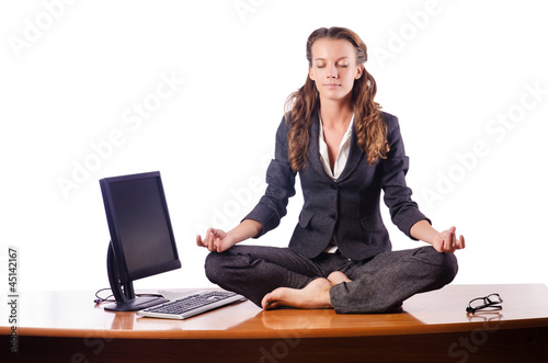 Photo: Woman meditating on the desk Woman meditating on the desk