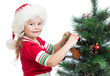 pretty preschool girl decorating Christmas tree isolated on whit