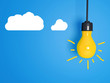 Yellow light bulb on blue background.