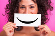 Young Woman with Smiley Emoticon on Fuchsia Background