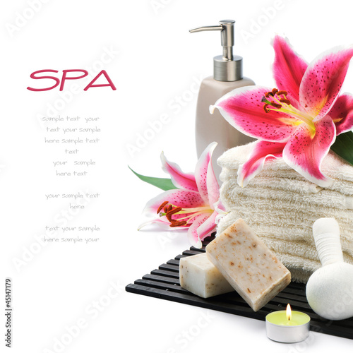 Photo: Spa setting with towels, organic soap and lily Spa setting with towels, organic soap and lily