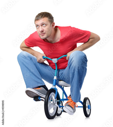 Photo: The curious man on a children's bicycle, on white background The curious man on a children's bicycle, on white background