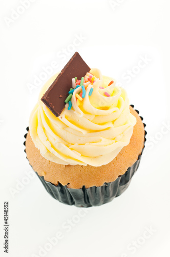 Photo: Vanilla cupcake vertical close up Vanilla cupcake vertical close up