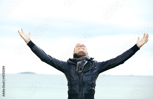 Photo: Woman rejoicing with arms outspread Woman rejoicing with arms outspread