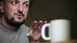 Adult Man in Pensive Mood Drinks Cup of Coffee
