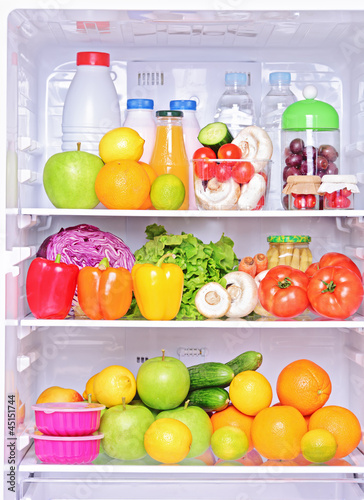 Photo: Shot of an open fridge with food products Shot of an open fridge with food products