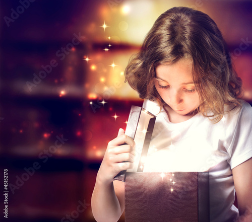 Photo: Happy Girl Opening a Present Happy Girl Opening a Present
