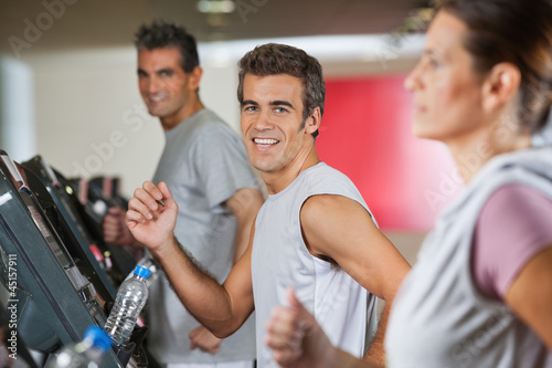 Photo: Men And Woman Running On Treadmill Men And Woman Running On Treadmill