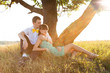 Young couple lying under the tree