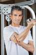 Mature Man Working Out In Fitness Center