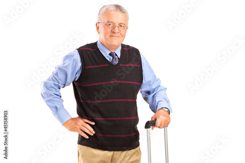Photo: A mature man holding a suitcase A mature man holding a suitcase