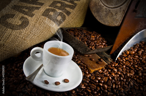 Photo: Coffee smoking on the coffee beans background Coffee smoking on the coffee beans background