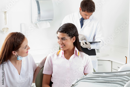 Photo: Nurse Communicating With Female Patient At Dental Clinic Nurse Communicating With Female Patient At Dental Clinic