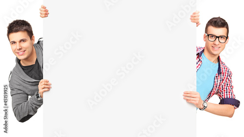 Photo: Two smiling men holding a blank panel Two smiling men holding a blank panel