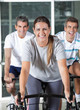 Men And Woman On Exercise Bikes