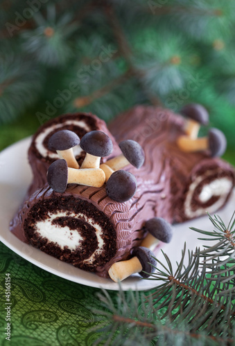 Photo: Traditional Christmas Yule Log cake, selective focus Traditional Christmas Yule Log cake, selective focus
