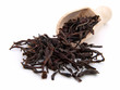 Photo: dry black tea leaves on the wooden spoon, on white background dry black tea leaves on the wooden spoon, on white background
