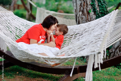 Photo: outdoors in a white hammock relax the mother and son in kasnyh s outdoors in a white hammock relax the mother and son in kasnyh s