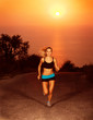 Woman run along the road