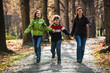 Active family - mother and kids walking, running outdoor