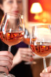 Toast in restaurant with full glasses of wine