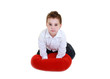 Foto: Funny child with red heart isolated on white background Funny child with red heart isolated on white background
