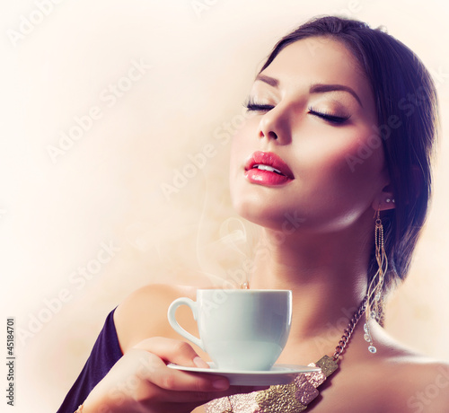 Photo: Coffee. Beautiful Girl Drinking Tea or Coffee Coffee. Beautiful Girl Drinking Tea or Coffee
