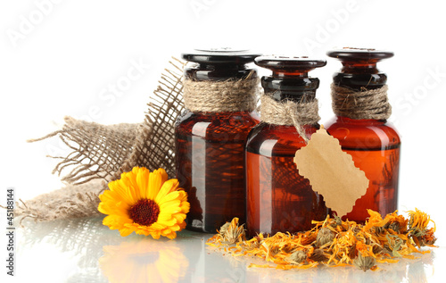 Photo: medicine bottles and calendula, isolated on white medicine bottles and calendula, isolated on white