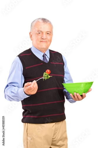 Photo: Mature gentleman eating a salad Mature gentleman eating a salad