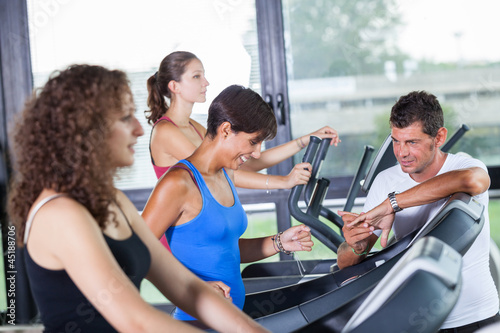 Photo: People Running on Treadmill in the Gym People Running on Treadmill in the Gym