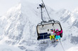 Skiing, winter  - happy skiers on ski lift