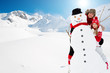 Winter fun, snowman and happy family