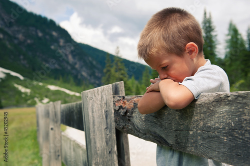 Photo: Portrait of four year old boy outdoors in the mountains. Portrait of four year old boy outdoors in the mountains.