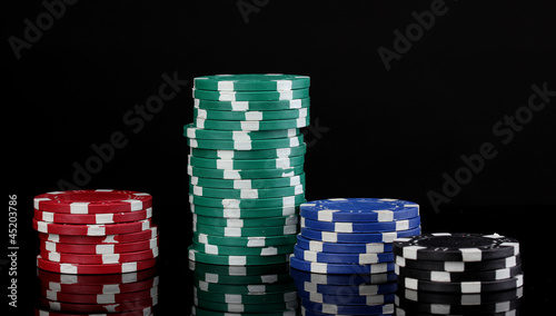 Photo: Casino chips isolated on black Casino chips isolated on black