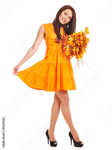 Photo: Woman holding orange leaves. Woman holding orange leaves.
