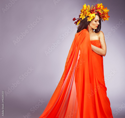 Photo: Girl with a wreath of autumn leaves on the head. Girl with a wreath of autumn leaves on the head.