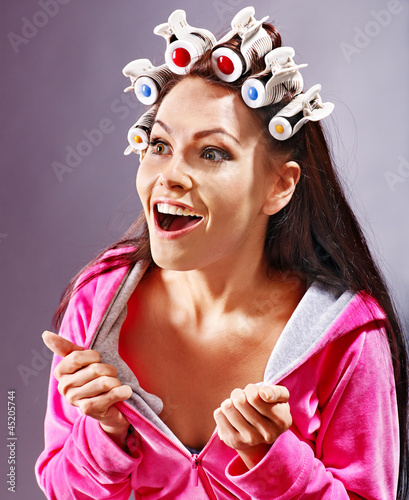 Photo: Woman wear hair curlers on head. Woman wear hair curlers on head.