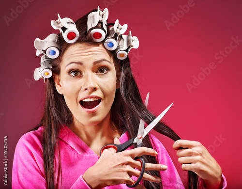 Photo: Woman wear hair curlers on head. Woman wear hair curlers on head.