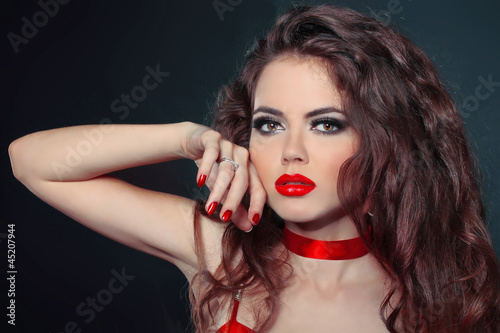 Photo: close-up portrait of woman with red lips and nails close-up portrait of woman with red lips and nails