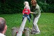 Oma mit 2 Enkeln auf Wippe