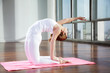Young Woman In Camel Position At Gym
