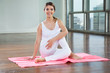 Happy Woman Practicing On Yoga Mat