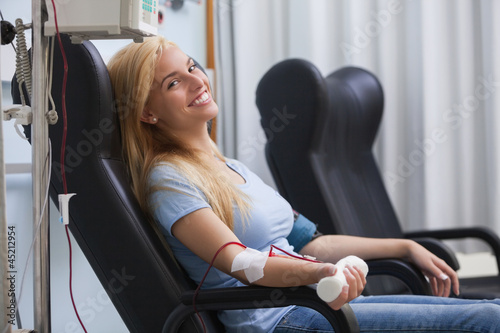 Photo: Smiling woman donating blood Smiling woman donating blood