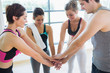 People at the gym putting hands together