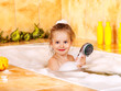 Child washing in bubble bath .